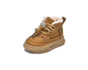 Detail view of winter kids' snow boots with thick white faux fur lining for warmth