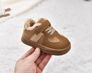 Detail of warm brown suede toddlers snow boots with thick faux lamb wool lining and strap