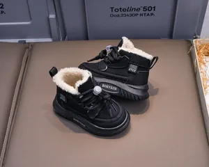 Detail of warm black winter boots for kids with plush white fleece lining and elastic laces