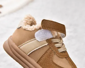 Detail view of children's winter snow boots featuring warm lamb wool lining and velcro strap