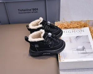 Detail of warm black winter boots for kids featuring thick faux fur lining and bungee cord