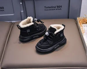 Detail of warm black winter boots for kids featuring thick fleece lining and drawstring
