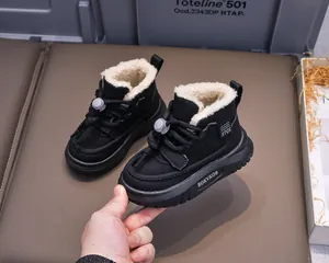 Detail of warm winter snow boots for kids featuring thick white fleece lining and waterproof upper