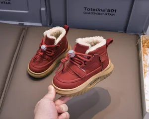 Detail of warm plush lining and side velcro on dark red winter boots for children