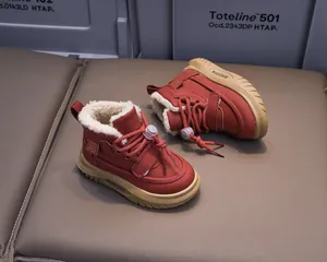 Close-up of winter kids boots featuring warm white faux fur lining and plush burgundy suede