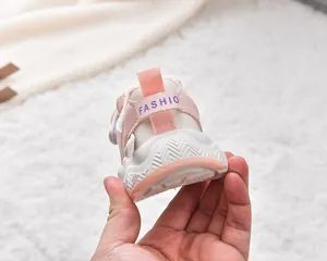Detail view of pink baby sneakers with warm fleece lining and non-slip rubber soles