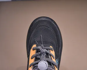 Macro view of kids snow boots showing durable rubber toe cap and adjustable laces