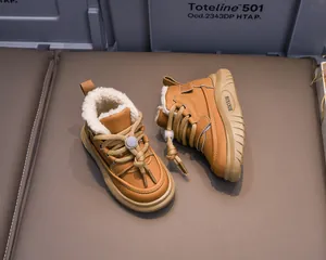 Detailed close-up of brown children winter boots featuring thick warm faux fur lining