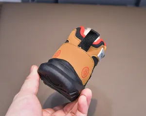 Close-up of kids winter snow boots showing warm white faux fleece lining and heel pull tab