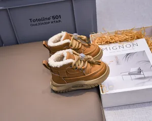 Detailed shot of camel winter boots for children featuring warm plush faux lamb wool lining