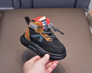 Close-up of children's winter boots with warm red faux fur lining and bungee lace toggle