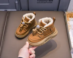 Detailed view of brown kids winter boots with thick white faux fur lining and drawstring