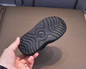 Close-up of durable black anti-slip rubber sole with deep wave patterns for toddler snow boots