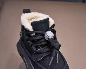 Detailed close-up of kids winter boots with warm fleece lining and bungee drawstring laces