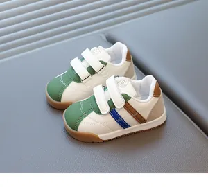 Detailed view of kids' retro sneakers with green rubber toe and velcro straps