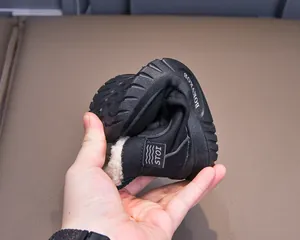 Close-up showing the extreme flexibility and soft rubber sole of kids winter snow boots
