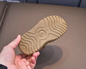 Close-up of durable non-slip rubber sole with deep wave patterns and size 24 mark
