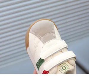 Detailed close-up of kids' retro sneakers with suede toe cap and double velcro straps