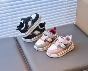Detail of kids casual sneakers featuring hook and loop straps and quilted leather texture