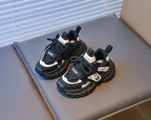 Detail view of children's mesh running shoes with breathable fabric and M logo