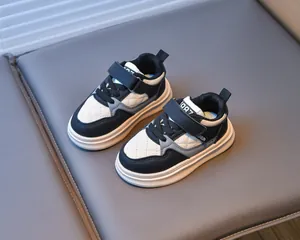 Detail of children's sneakers with black and white color block and velcro strap