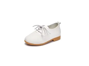 Close-up of white leather Oxford shoes for children with refined lychee grain texture