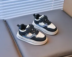 Detail of children sneaker featuring quilted leather, velcro strap and FASHION label