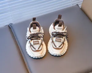 Detail of girls' chunky beige and brown running shoes with durable anti-slip sole