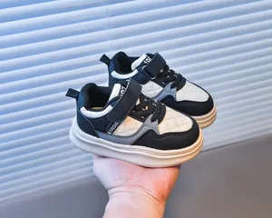 Detail of kids sneaker showing waterproof leather, quilted texture, and velcro closure
