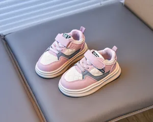 Detail of pink and white kids' sneakers with quilted leather and velcro straps