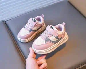 Detail of pink and white girl's sneakers with diamond quilting and Velcro straps
