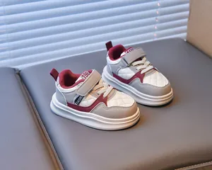 Detail of children's patchwork sneakers with velcro straps and anti-slip thick soles