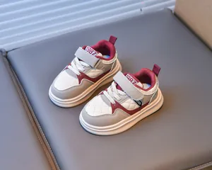 Detail of kids sneaker with quilted synthetic leather in beige, grey and burgundy
