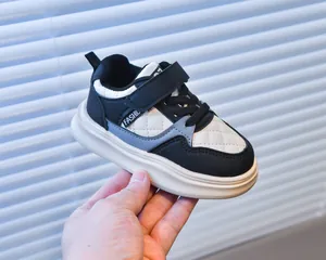 Detail of children's sneaker showing velcro strap and textured diamond-quilted pattern