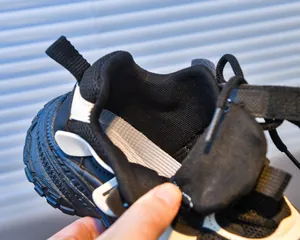 Detailed macro view of breathable mesh material and thick rubber sole on girls' sneakers