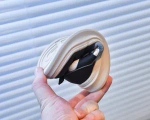 Close-up showing the flexible rubber sole of the kids' black and white sneakers