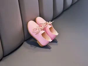 Close-up of pink leather girls' shoes with lace-up design and anti-slip rubber sole