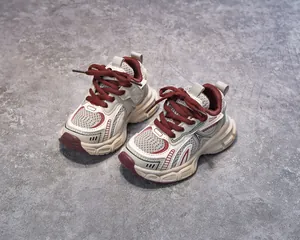 Detail of kids chunky sneakers featuring mesh leather patchwork and non-slip thick soles
