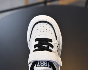 Close-up of leather sneaker upper with 1987 logo and velcro strap detailing
