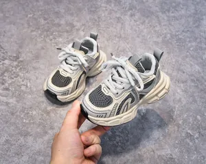 Close-up of kids breathable mesh chunky sneakers in grey and off-white with thick sole