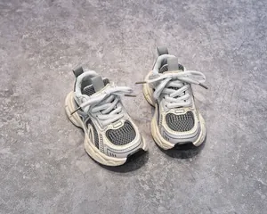 Detail view of chunky children's sneakers with mesh texture and anti-slip thick soles