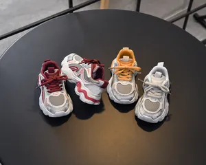 Top view of multi-colored kids chunky sneakers with breathable mesh and thick wavy soles