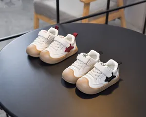 Detail view of anti-collision toe cap and star decoration on kids sport shoes