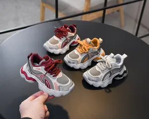 Detailed top view of breathable mesh toddler sneakers in burgundy yellow and grey colors