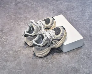 Detailed view of kids' retro sports sneakers with mesh fabric and anti-slip sole