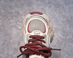 Macro shot of mesh toe cap and red laces on children athletic sneakers
