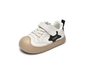 Detail view of children's non-slip sneakers with star patch and hook-and-loop closure