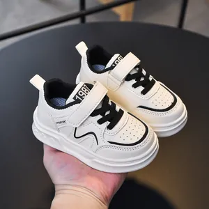 Classic white children's leather sneakers with black accents and durable rubber soles