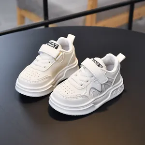 Kids white leather sneakers with velcro closure and poker pattern soles for boys and girls