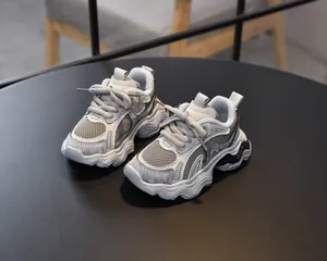 Detail of girls grey mesh daddy sneakers with thick wavy sole and hook-and-loop closure